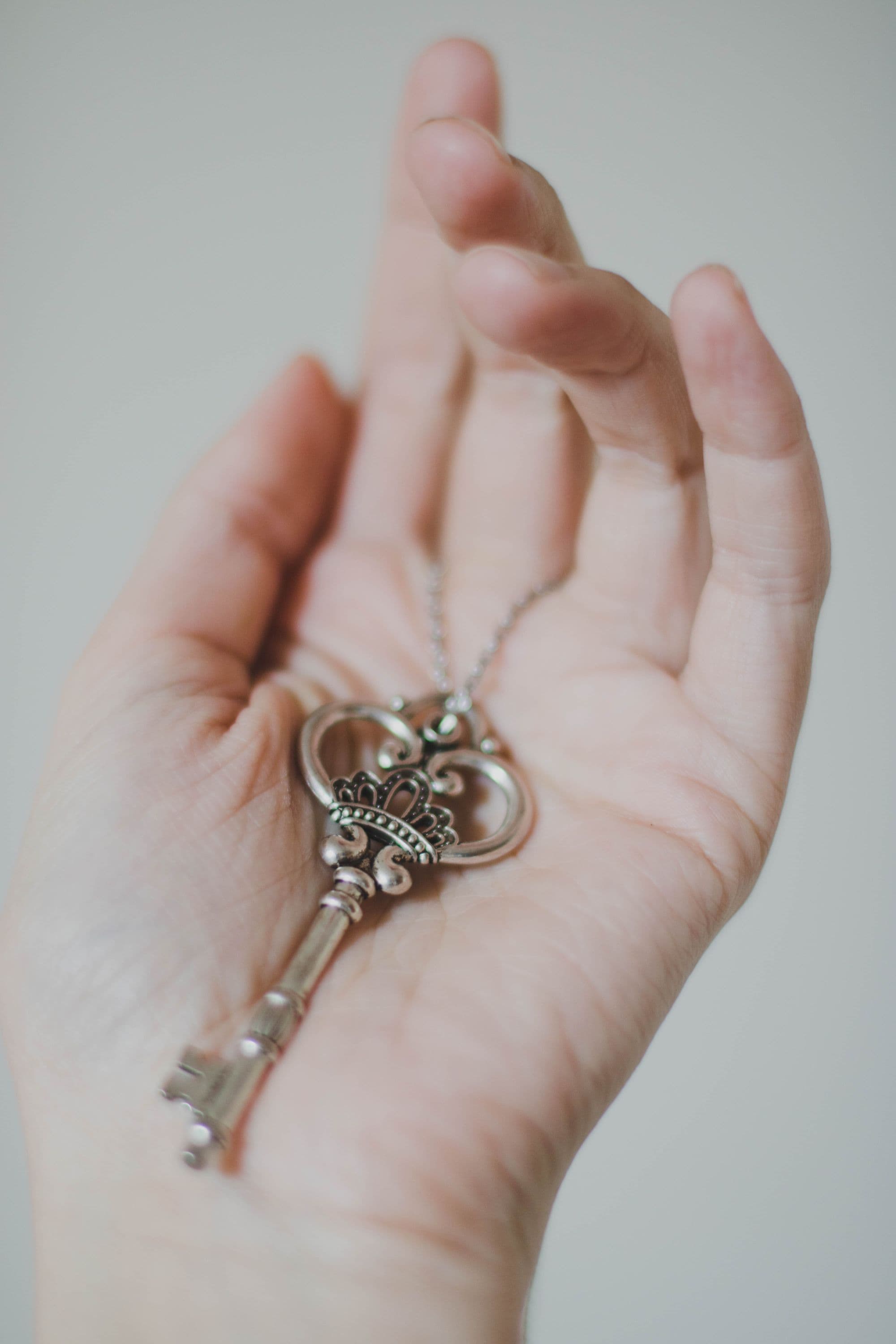 An antique key resting in an open hand
