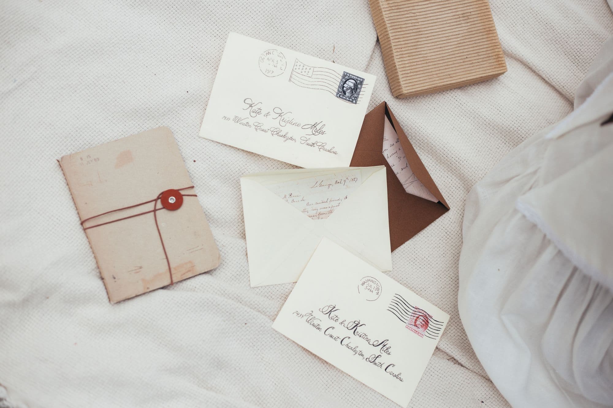 Old letters and a wax-sealed envelope tied with string on white linen